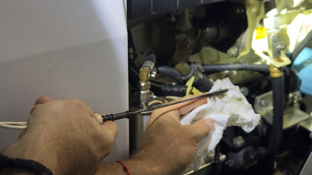 Checking engine oil condition during a yacht inspection